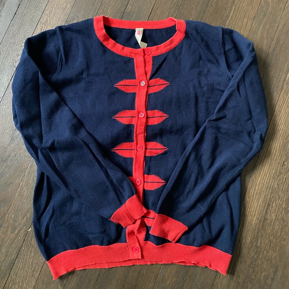 Navy button up sweater with red detail